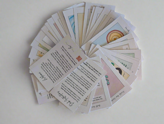 Collection of cards with various designs and text on a white surface