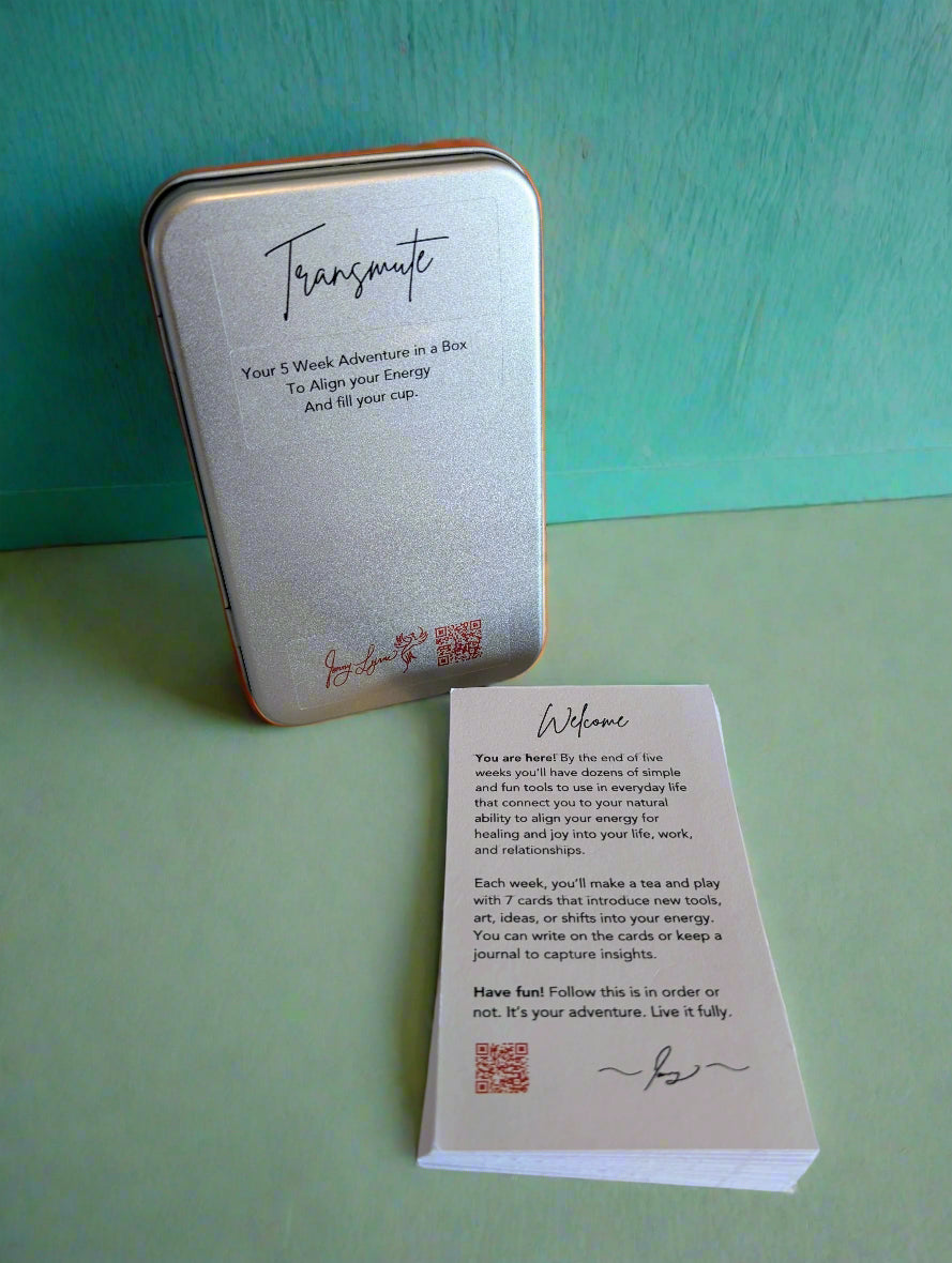 Silver tin labeled 'Transmute' with a white card on a light surface