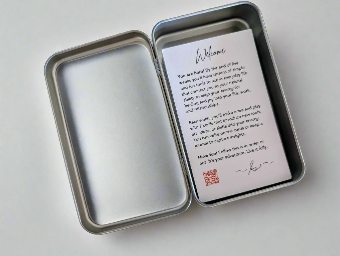 Metal tin with a welcome card inside on a white background
