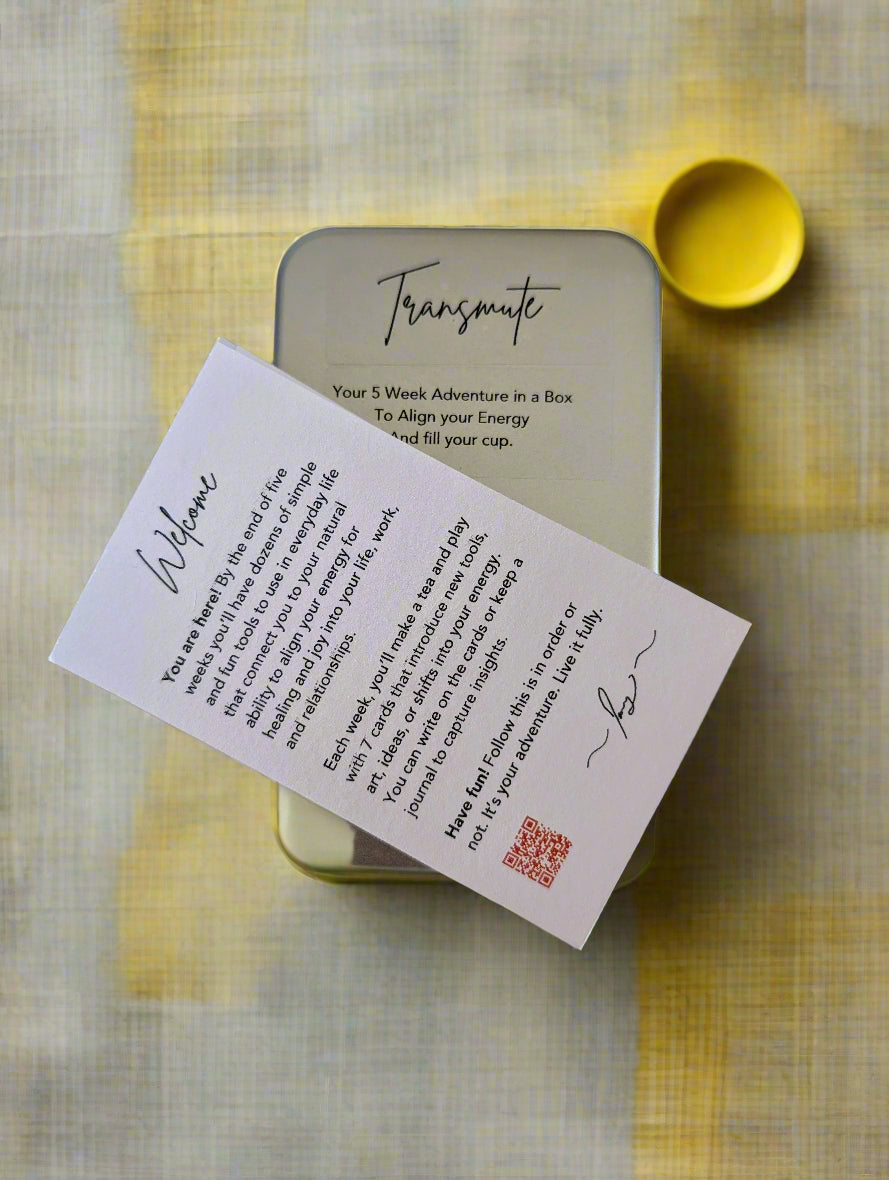 Small tin labeled 'Transmute' with a welcome card featuring text and a QR code on a white background