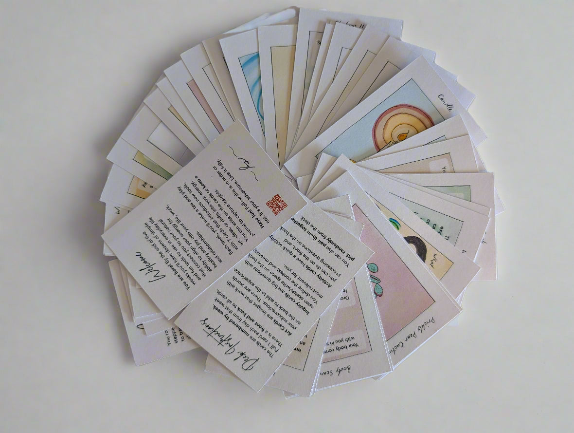 Collection of cards with various designs and text on a white surface